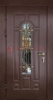 Темная железная дверь со стеклом и ковкой для частного дома ДСК-156 в Домодедово